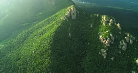 Aerial view of picturesque cliffs and green mountain slopes outside the city. Stock Footage 158398970