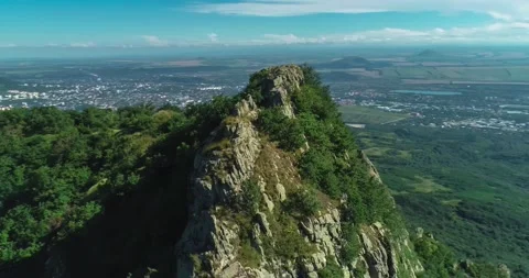 Aerial view of picturesque cliffs and green mountain slopes outside the city. Stock Footage 158401239
