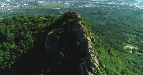 Aerial view of picturesque cliffs and green mountain slopes outside the city. Stock Footage 158401647