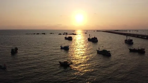 Aerial View of the Pier on the Ocean At Sunset, View of the Sun and the Ocean In Stock Footage 166344057