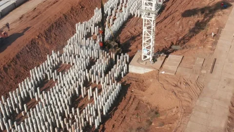 Aerial view of pile driving machine with reinforced concrete piles and Cran on Stock Footage 143539141