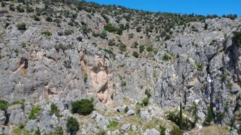 Aerial view of pilgrimage chapel on cliffside above rugged canyon Stock Footage 343945462