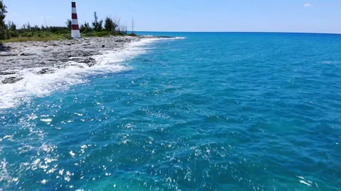 Aerial View of Pinders Point Lighthouse and Waves on Rocky Shore, Bahamas Stock Footage 107295451