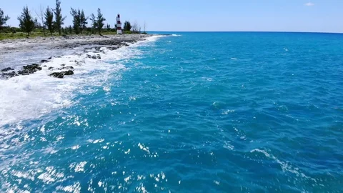 Aerial View of Pinders Point Lighthouse and Waves on Rocky Shore, Bahamas Stock Footage 107295461