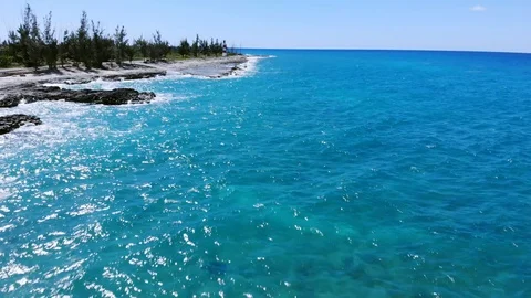 Aerial View of Pinders Point Lighthouse and Waves on Rocky Shore, Bahamas Stock Footage 107295498