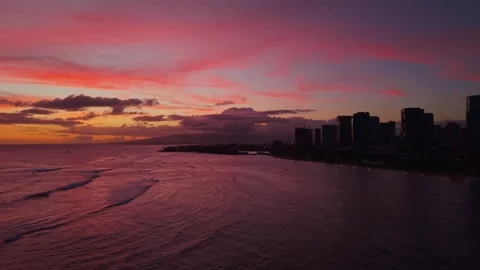 Aerial view of pink sunset over ocean with palm silhouettes in Hawaii 2 Stock Footage 346427930