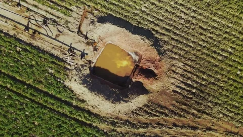 Aerial view of pit filled with water. Gas production process. Gas field Stock Footage 219952909