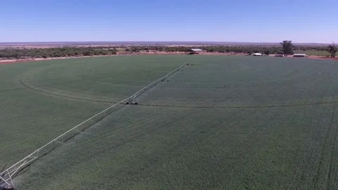 Aerial View of Pivot Irrigation System in Action on a Sunny Day Stock Footage 243572242