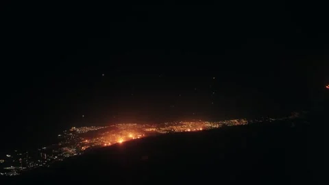 Aerial view from plane flight of city in Kuwait with glowing oil plant fires  Stock Footage 336077571