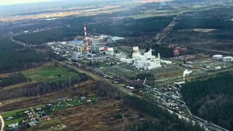 Aerial View From Plane of Large Industrial Power Plant Surrounded by Forest in Stock Footage 336523437