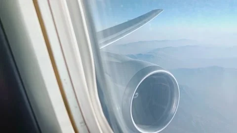 The aerial view from the plane window on airplane wing and turbine, mountains Stock Footage 221133705