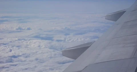 Aerial view from plane window of beautiful white cumulus clouds Stock Footage 339057594