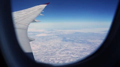 Aerial: view from plane window flying over snowy Wisconsin Stock Footage 235650538