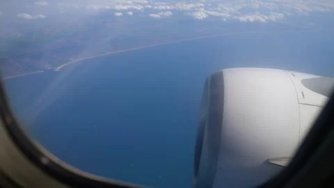 Aerial View From Plane Window Showcasing Airplane Engine and Coastline Under Stock Footage 301913506