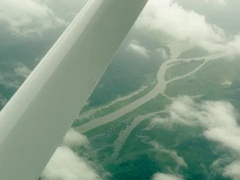 Aerial view from a plane window shows a curved river Stock Photos