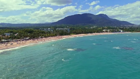 Aerial view of Playa Dorada beach and mountains in background, Dominican Stock Footage 331758210