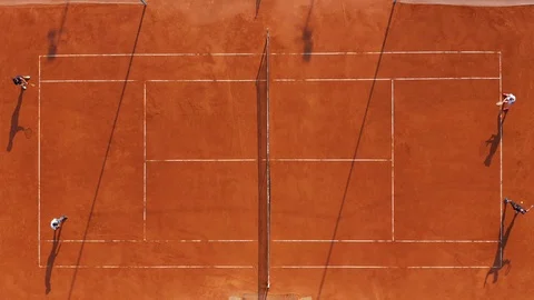 Aerial view. Players are playing tennis on orange court. Stock Footage 112688165