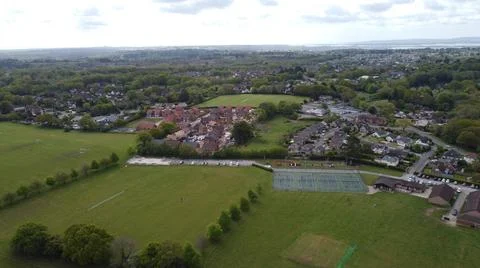 Aerial view of playing fields, trees and new housing development Stock Photos