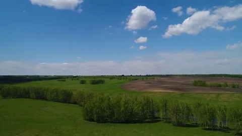 Aerial view of ploughed fields and cloud forest of the Siberian landscape Stock Footage 75810768