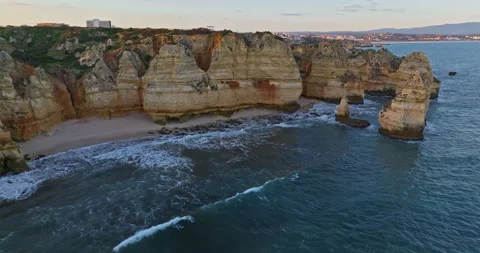 Aerial view of the point dramatic cliffs and lighthouse of Ponta da Piedade at Video stock 310682040
