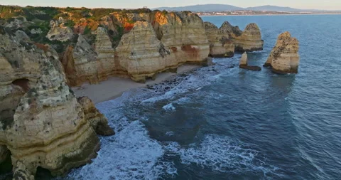 Aerial view of the point dramatic cliffs and lighthouse of Ponta da Piedade at 動画素材 311031922