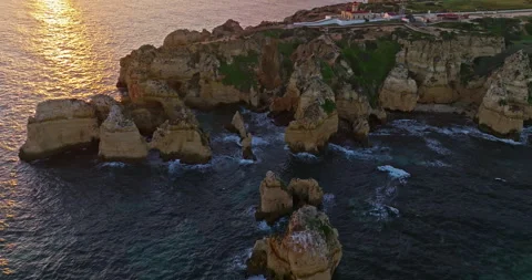 Aerial view of the point dramatic cliffs and lighthouse of Ponta da Piedade at Video stock 311112462