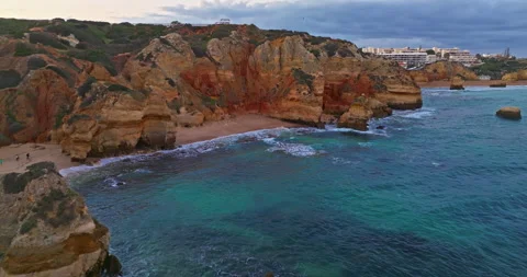 Aerial view of the point dramatic cliffs and lighthouse of Ponta da Piedade at Stock Footage 311113401
