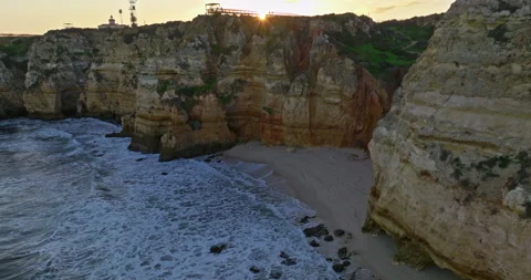 Aerial view of the point dramatic cliffs and lighthouse of Ponta da Piedade at Stock-Footage 311493662