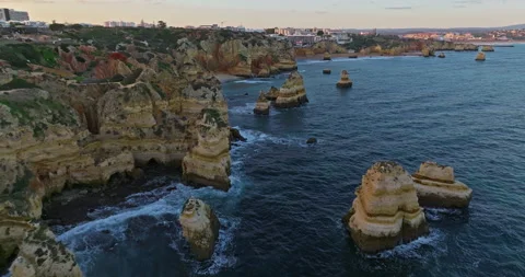 Aerial view of the point dramatic cliffs and lighthouse of Ponta da Piedade at Video stock 311804914