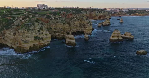 Aerial view of the point dramatic cliffs and lighthouse of Ponta da Piedade at Video stock 311806980