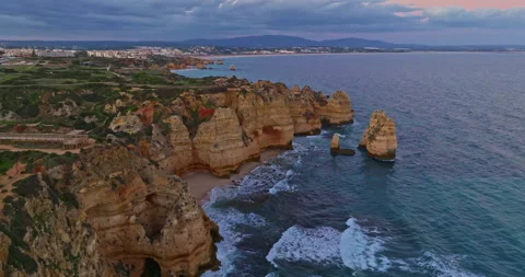 Aerial view of the point dramatic cliffs and lighthouse of Ponta da Piedade at Video stock 312271714