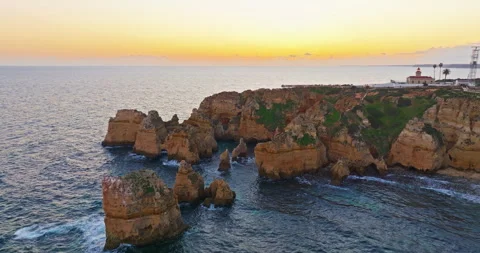 Aerial view of the point dramatic cliffs and lighthouse of Ponta da Piedade at Video stock 312275473