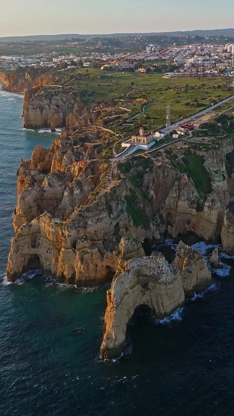 Aerial view of the point dramatic cliffs and lighthouse of Ponta da Piedade at Vidéo 320886928
