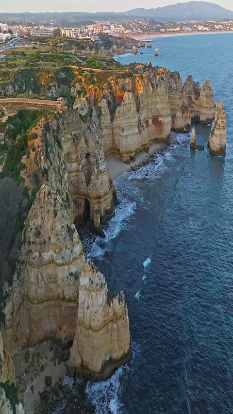 Aerial view of the point dramatic cliffs and lighthouse of Ponta da Piedade at Video stock 320900537