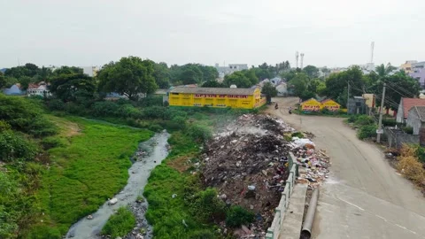 Aerial View of Polluted River Stream with Garbage Dumping Along Banks in Urban Stock Footage 316723055