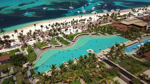 Aerial view of pool on the grounds of a luxury hotel in the tropics. Palm trees Stock Footage 274371943