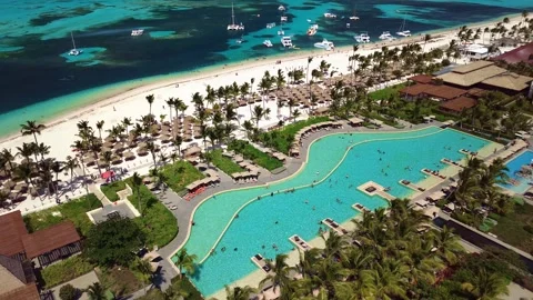 Aerial view of pool on the grounds of a luxury hotel in the tropics. Palm trees Video stock 274371954