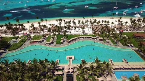 Aerial view of pool on the grounds of a luxury hotel in the tropics. Palm trees Stock Footage 274372071