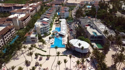 Aerial view of pool on the grounds of a luxury hotel in the tropics. Palm trees Stock Footage 274372181