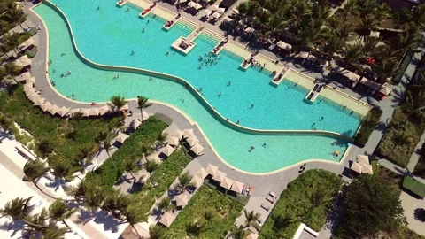 Aerial view of pool on the grounds of a luxury hotel in the tropics. Palm trees Stock Footage 274372230