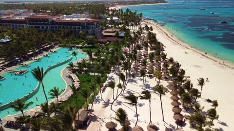 Aerial view of pool on the grounds of a luxury hotel in the tropics. Palm trees Stock Footage 274372391