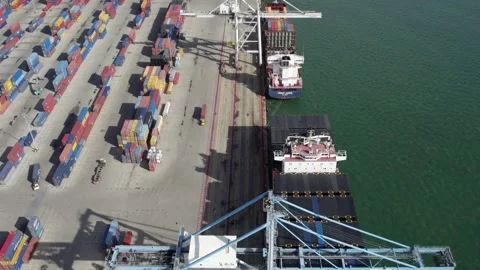 Aerial view of the port, cargo container ship and crane in the seaport Stock-Footage 258473542