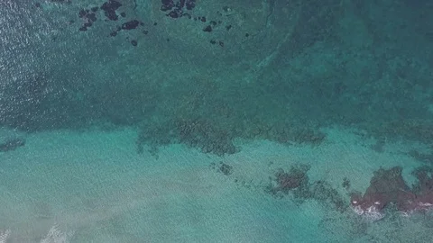 Aerial view of a portion of ocean with crystal blue water shot from drone in 4k Video stock 83443214