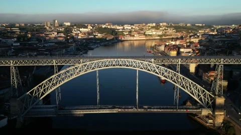 Aerial view of Porto, Douro River and the tram crossing the bridge at sunrise Stock Footage 209137315