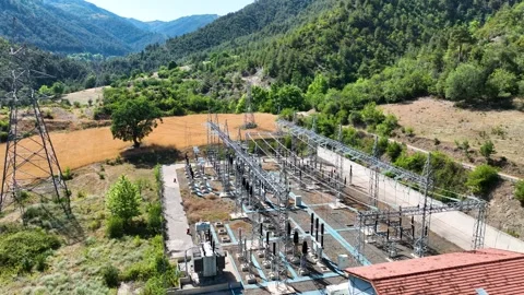 Aerial view of power distribution lines and substation at hydro plant Stock Footage 324539441