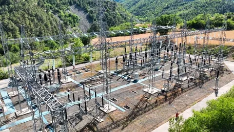 Aerial view of power distribution lines and substation at hydro plant Stock Footage 324539686