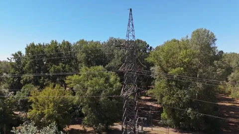 Aerial view of power lines and towers over forest near Tiszaújváros, Hungary Stock Footage 345537332