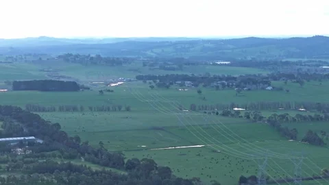 Aerial view of power lines over green rural landscape Видео 342525025