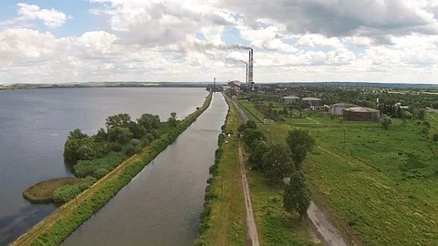 Aerial view of power station on the shore a large lake Stock Footage