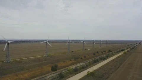Aerial view power wind generators spinning near with road in filed Stock Footage 118742758